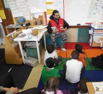 Marvin Mancia, Assistant Manager at Annie’s Ace Hardware, reads to students at Powell Elementary