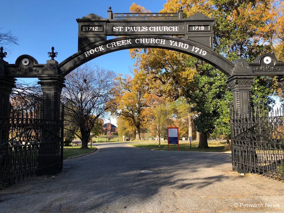 The gates of Rock Creek Church Cemetery, with the parish visible in the distance.