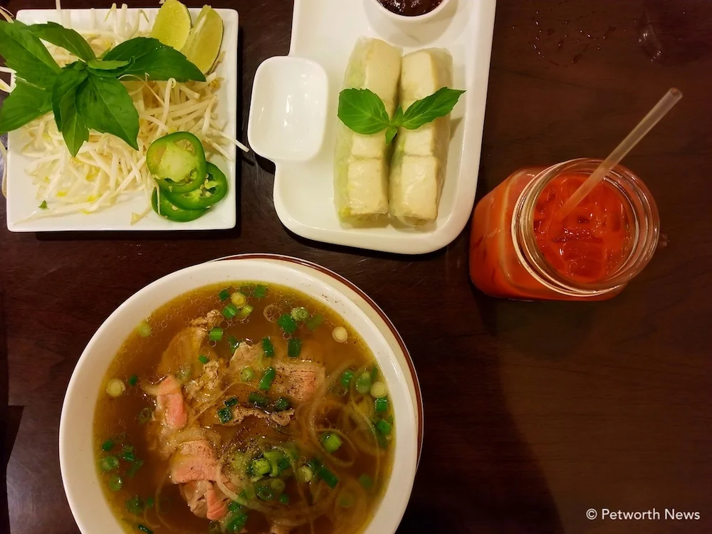 Beef pho with spring rolls and a Vietnamese ice tea