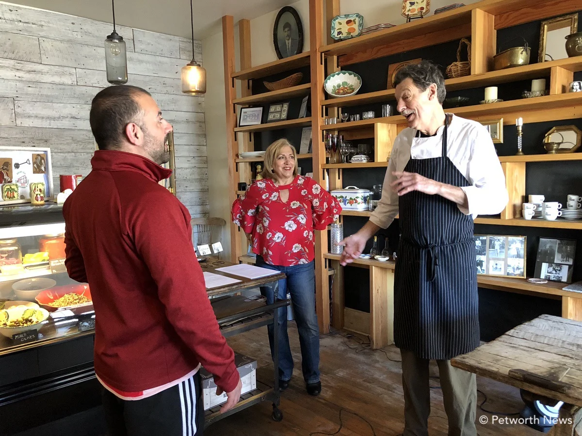 Karen and Chef Smith talk with a customer at the restaurant.