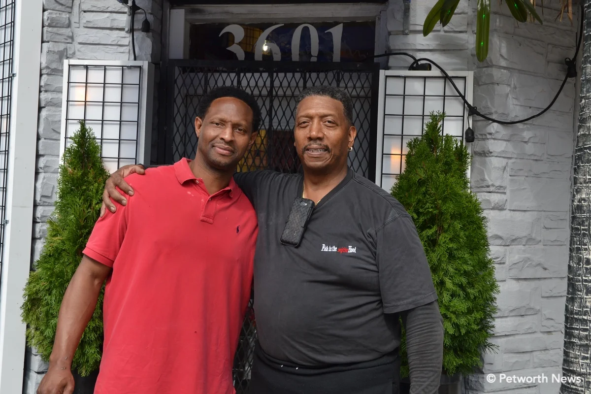 Santana Shabazz poses with Bill White, owner of Fish in the Neighborhood.