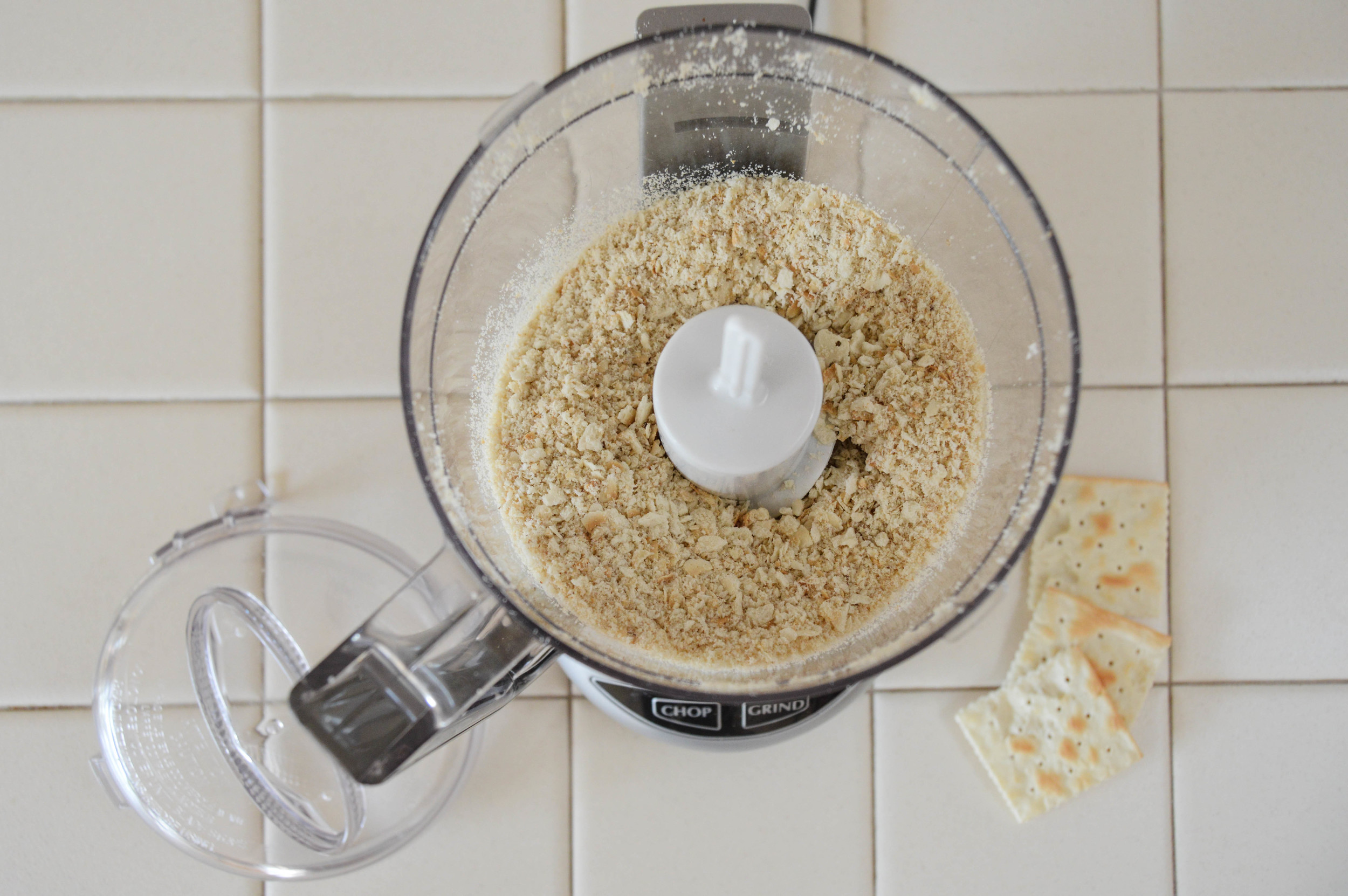 Chop crackers into fine crumbs. Set aside. Repeat with walnuts. If you do not have a food processor, crush crackers in a zip lock bag with rolling pin and finely chop nuts with a knife.