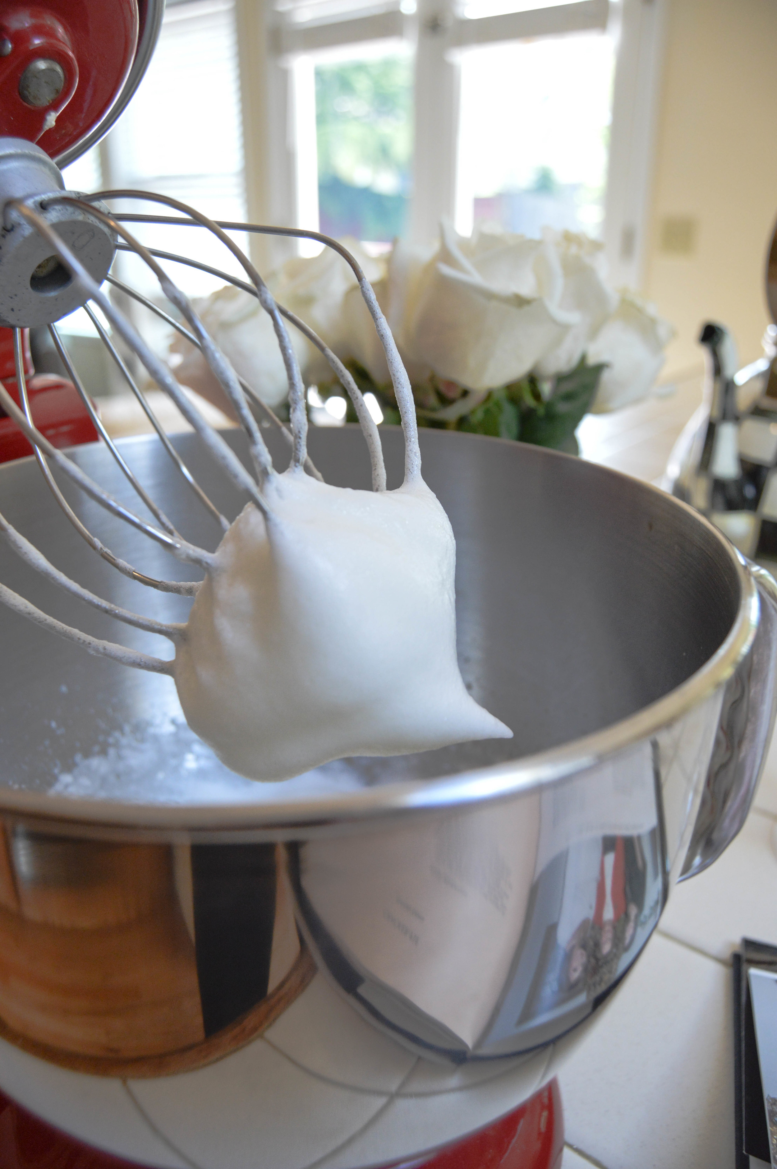 Beat egg whites until soft peak forms.