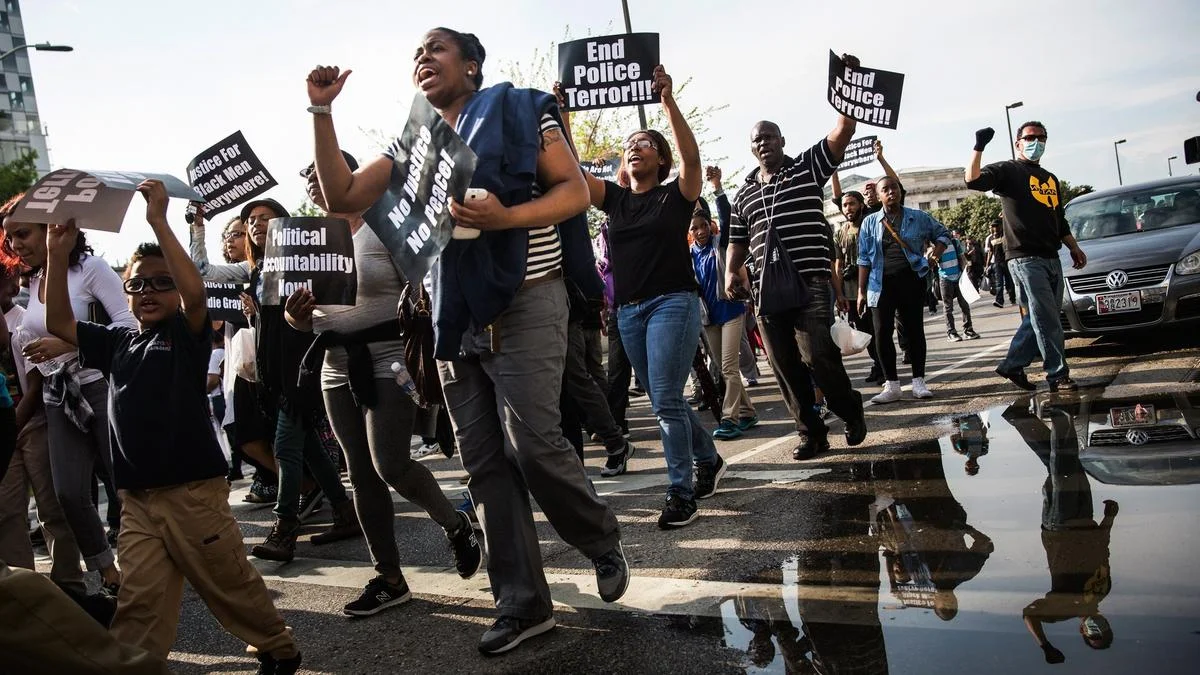 Protesters march on April 30 from Baltimore’s Sandtown neighborhood to City Hall, demanding better police accountability and racial equality following the death of Freddie Gray. (Andrew Burton / Getty Images)