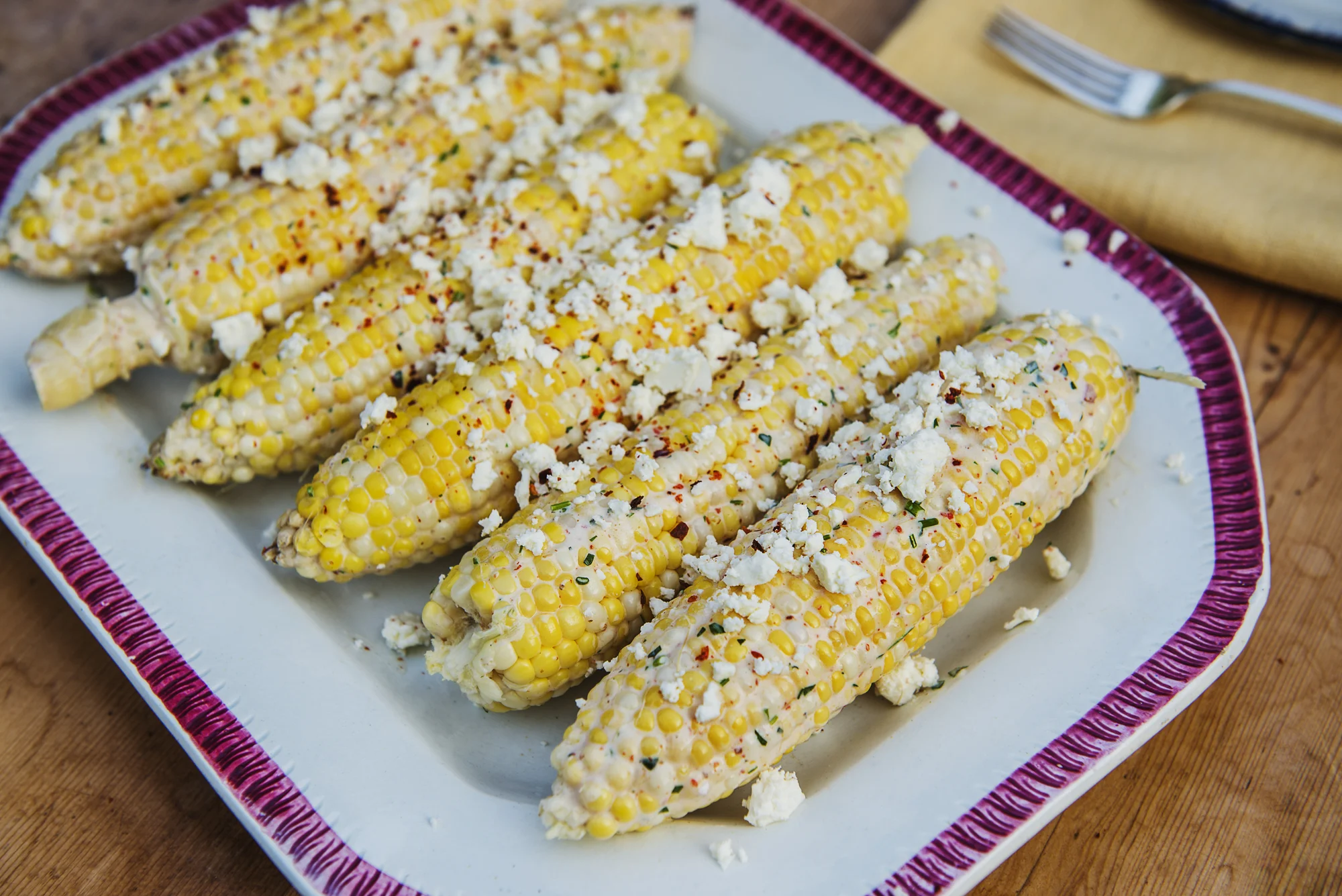 Marash Pepper Herbed Goat Cheese & Greek Yogurt Sauce for Grilled Corn Ingredients · 8 Ounces Plain Whole Milk Greek Yogurt · 4 Ounces Soft Mild Spreadable Goat Cheese · 2 Tablespoons Extra Virgin Olive Oil · 2 Tablespoons minced Chives · 2 Tablespoons minced Italian Parsley · 1 Tablespoon minced Fresh Mint Leaves · 1 Tablespoon minced Preserved Lemon Rind · 1 Tablespoon preserved Lemon Juice/Pulp · 1 - 1½ Teaspoons Marash Pepper or Crushed Red Pepper Flakes · 1 Teaspoon ground Coriander · Crumbled Feta for Garnish - Feta is used here to replace Jben, the commonly used Moroccan Cheese. Directions 1. Mix everything except the Feta together thoroughly. 2. Pull the and discard the husks from the grilled corn cobs. 3. Roll the corncobs in the spiced sauce to coat each thoroughly. 4. Crumble Feta to garnish the sauced grilled corncobs. My next post, Part 4 of the Picnic at Coastal Maine’s Mead Meadow is the finale to the feast. It will feature my homemade Maine blueberry cheesecake ice cream popsicles with a do-it-yourself dark chocolate magic shell coating. A perfect finish to a sumptuous summer supper al fresco!
