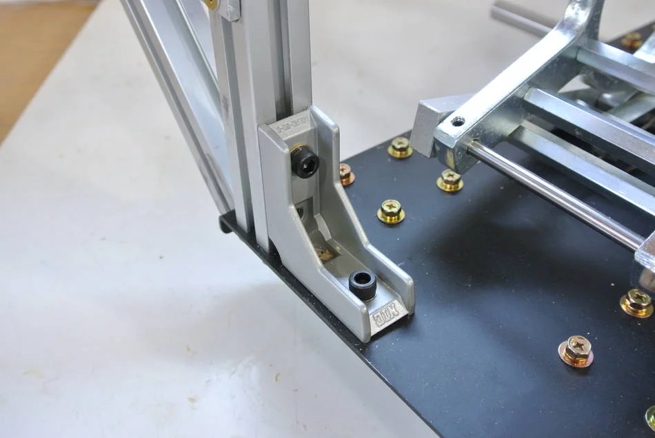 Install an angle brace on the plunge lever side. Slide a square nut into the channel to screw the angle brace into.