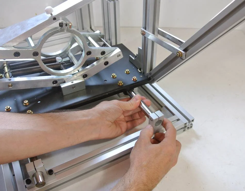 Slide the shaft forward enough to clear the rear shaft holder, then slide the rear shaft holder to line up with the shaft, and bring he shaft back far enough to go into the rear shaft holders.