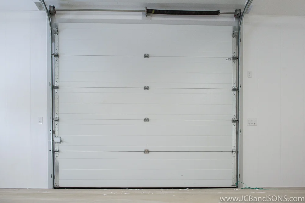 Completed overhead door installation in new pole shed addition near Holstein Ontario