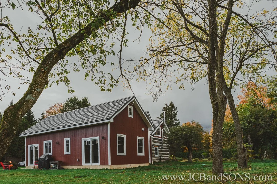 Completed angled view of new back addition blending with original log structure near Markdale, Ontario