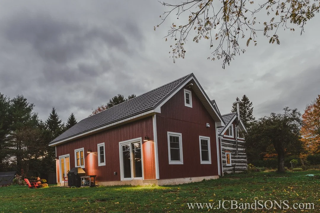 Completed angled view of new back addition blending with original log structure near Markdale, Ontario