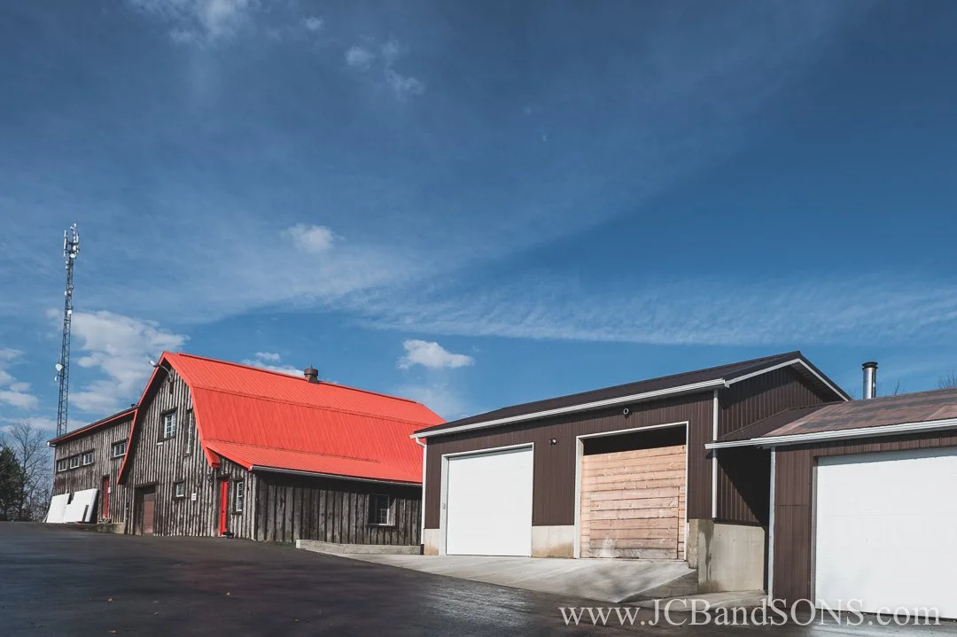 Completed concrete sidewalk and small retaining wall installation at driving shed near Hanover in rural West Grey
