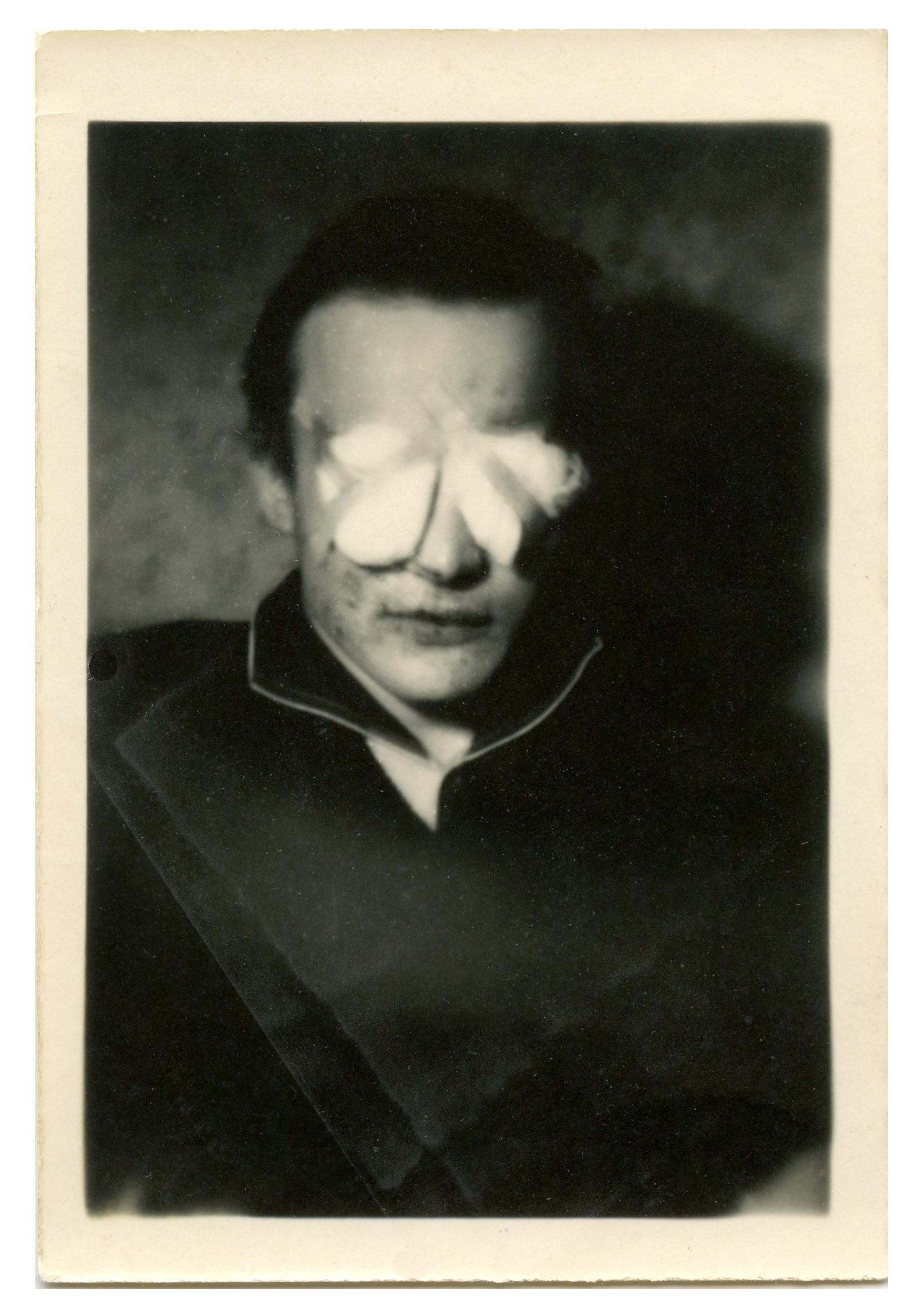 Strange snapshot of a man with bandaged eyes.
