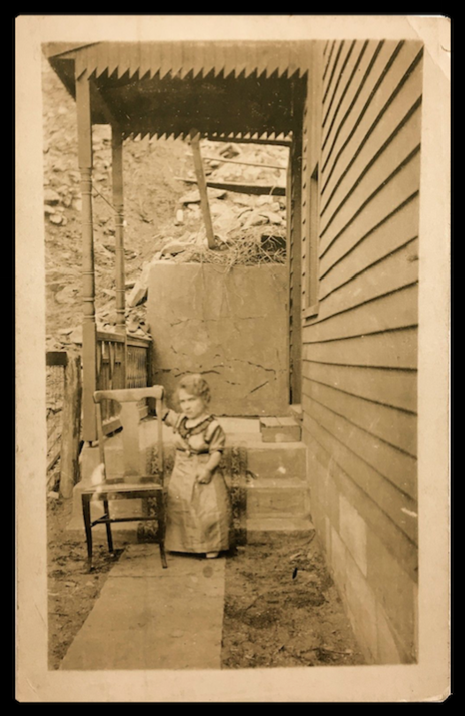 This little person seemed none to happy at having this photo made. The sawtooth pattern above only add to the uncomfortable moment. c. 1920