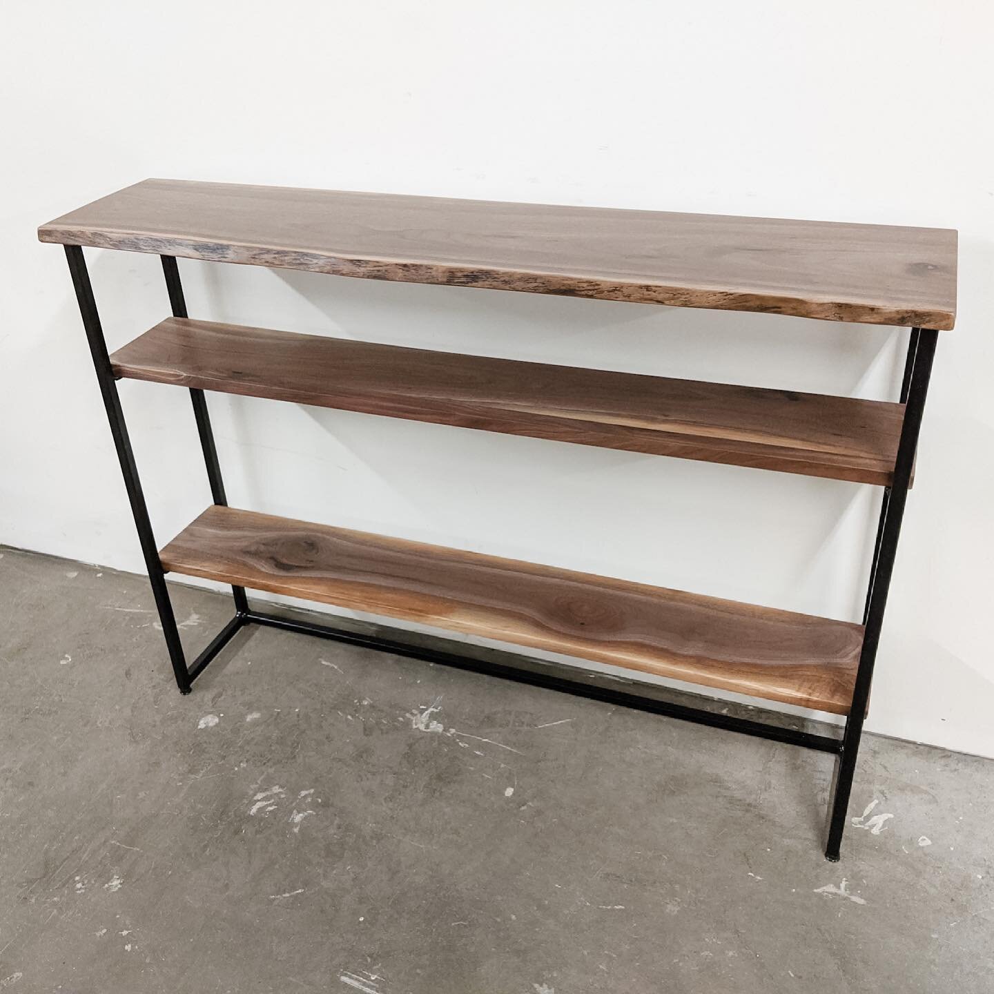 A sleek walnut console is perfect for so many spaces. With this piece, we added two shelves below for increased storage and styling opportunities.

#customfurniture #liveedge #customwoodwork #interiordesign #interiordecorating #livingroomdecor #livin