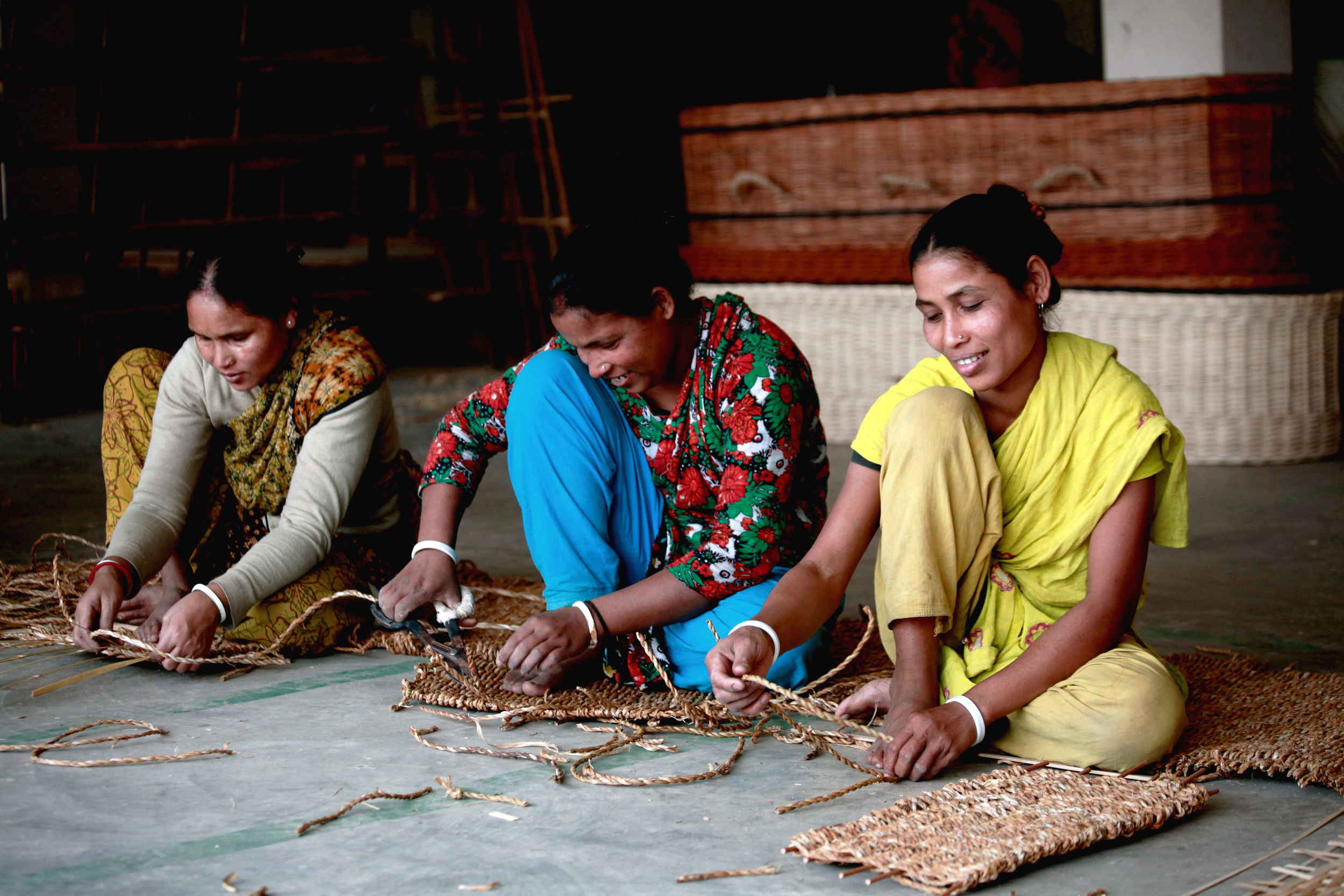  Workers weaving parts of a seagrass coffin 