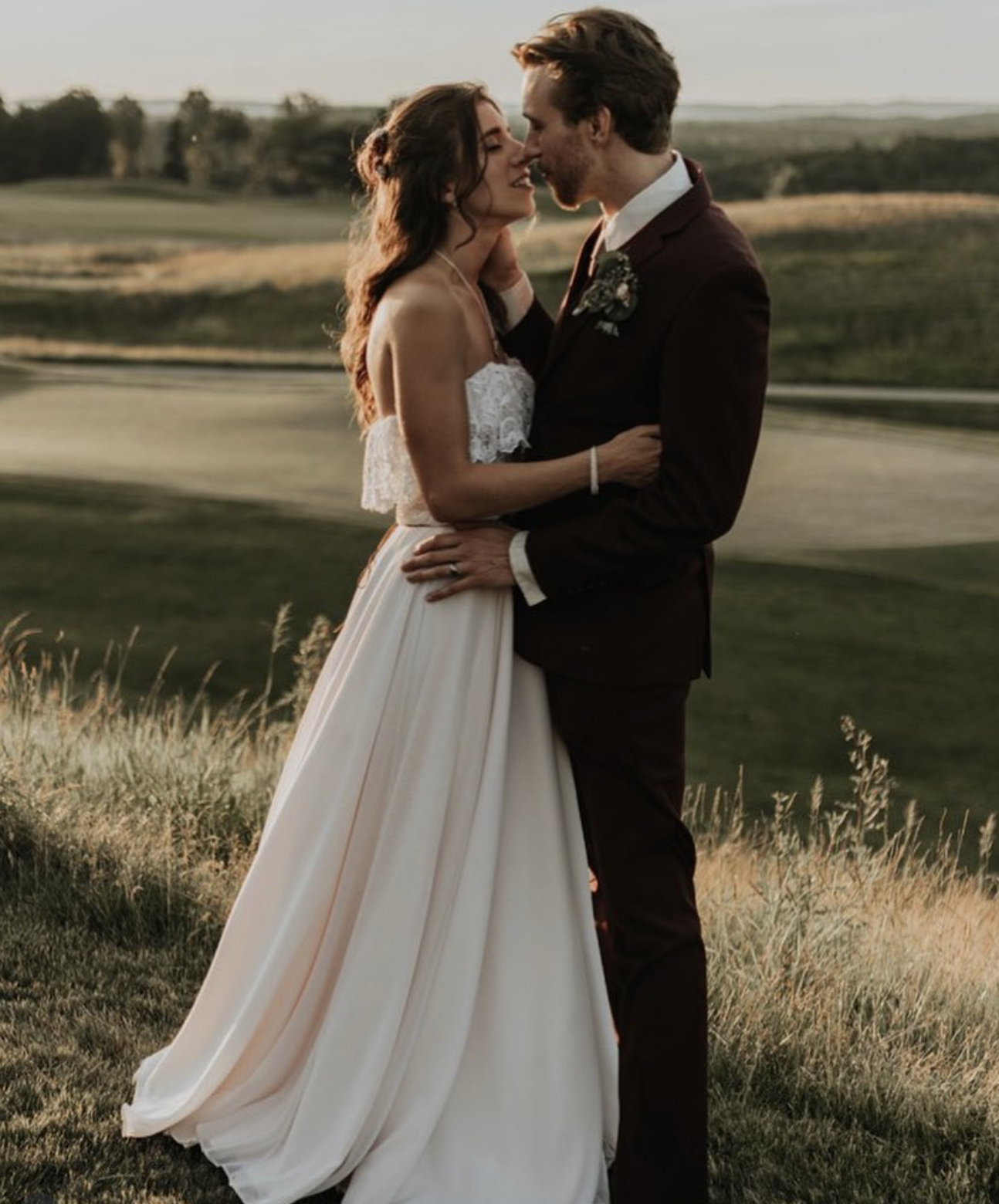 Kyle and Brittany sharing a romantic wedding portrait on the scenic hills of Ballyowen Golf Club.