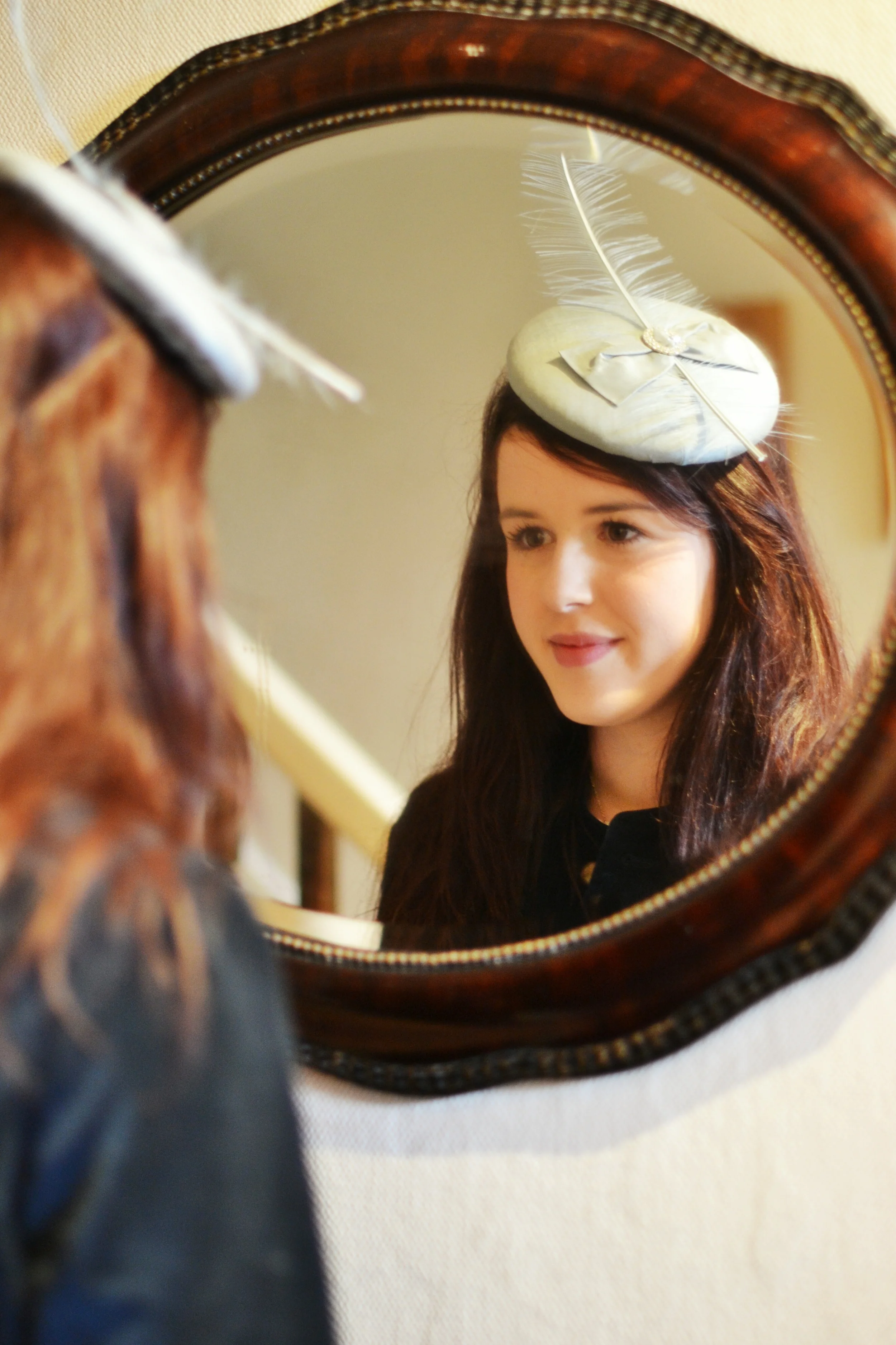 Silk button hat with flat bow, stripped ostrich feather and embellishment