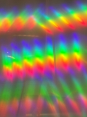 A photo taken through diffraction grating shows the two ends of the spectrum overlapping. Magenta appears when red light blends with blue light.