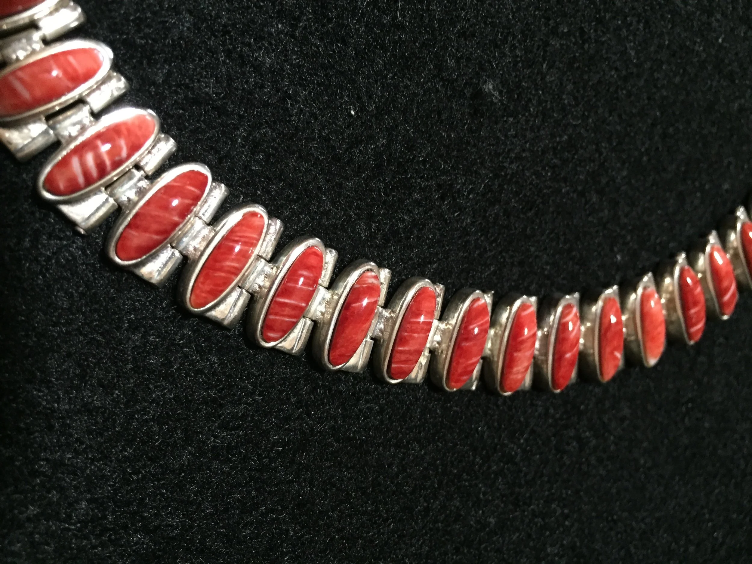 Links of silver overlayed with pink cabs