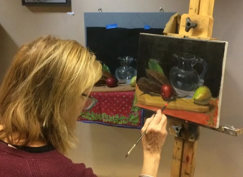 Students study still life painting using both indirect and all prima techniques.
