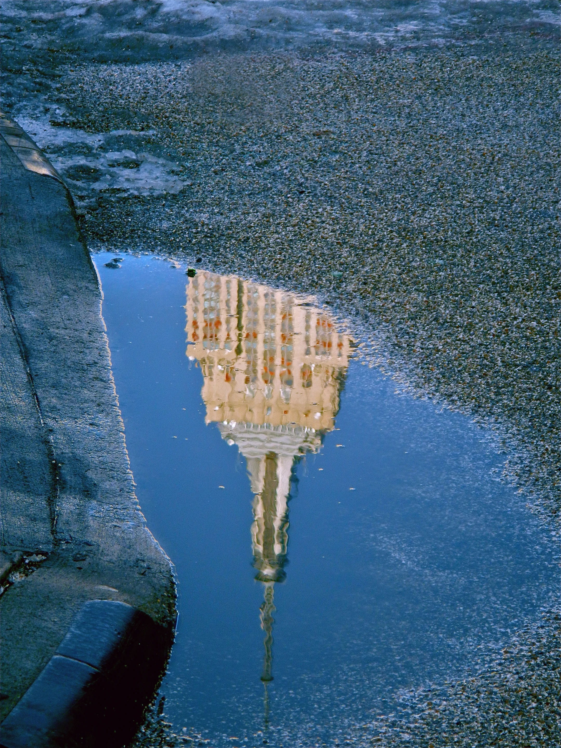  Empire State building reflected in puddle. 2013. 