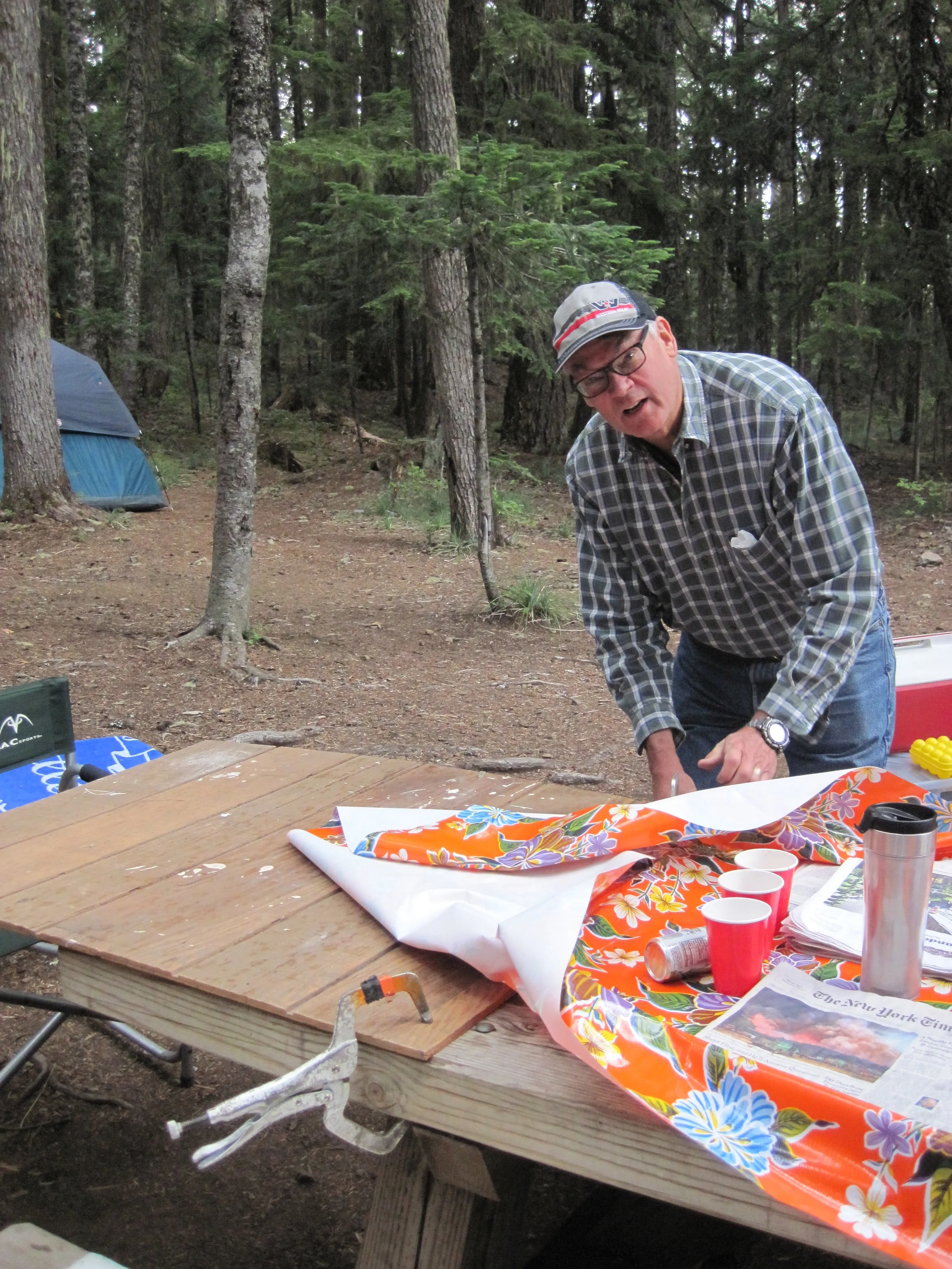 My uncle attaching a "leaf" to our picnic table so that more people could sit there. 