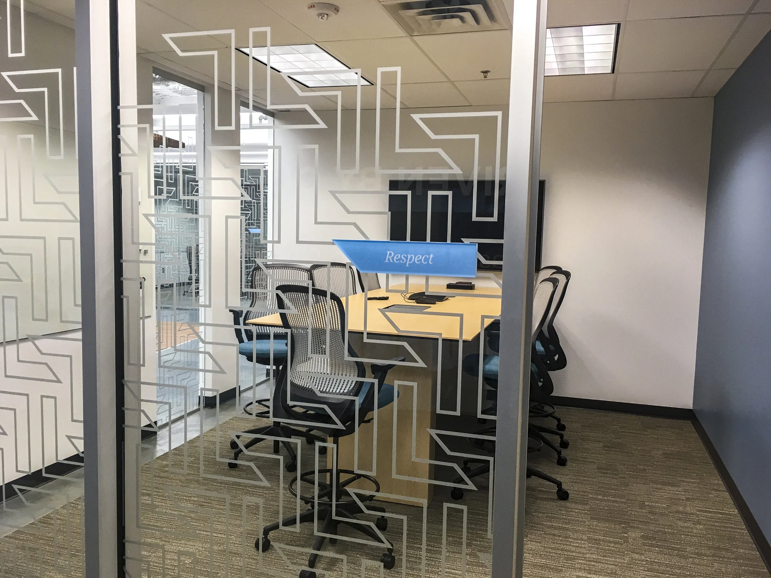 The logo “l’s” were created as a pattern on the conference room glass to create interest and privacy.