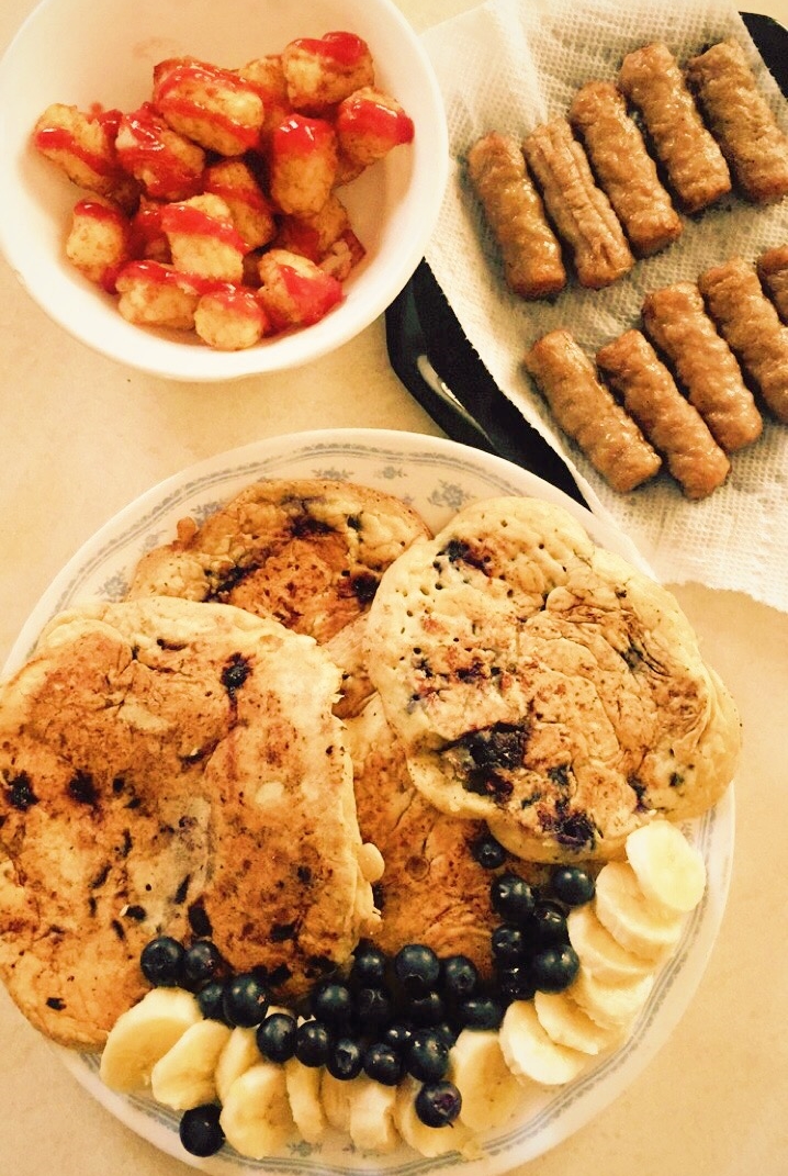 Chocolate chip blueberry pancakes, sausages, and tater tots