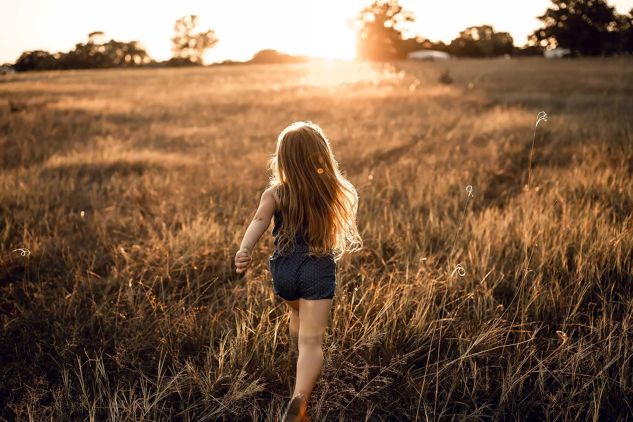 shelby-schiller-photography-child-running-into-the-summer-sunset.jpg