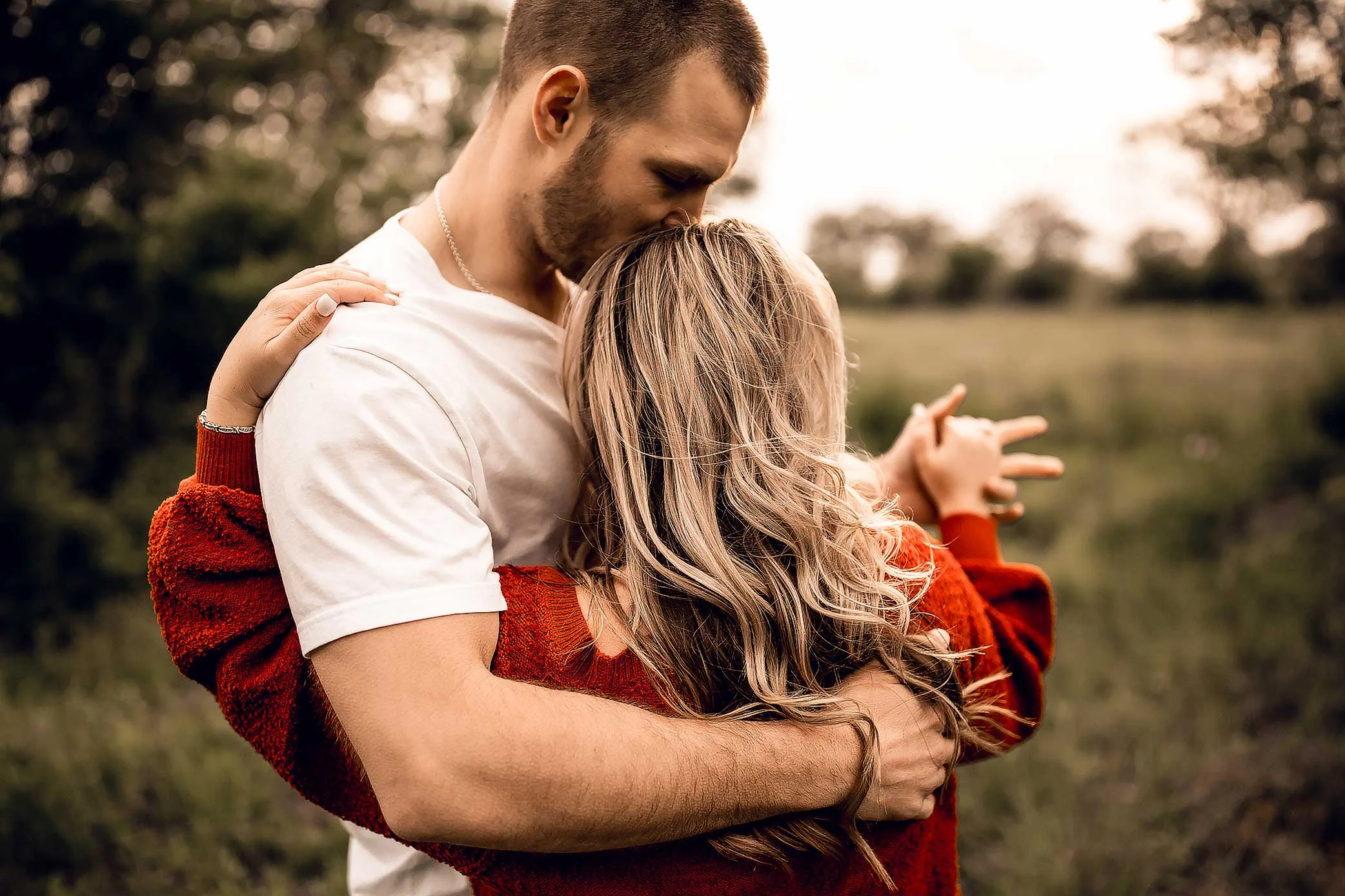 shelby-schiller-photography-couples-detail-shot-of-dancing-and-wind-blowing-rust-colored-sweater.jpg