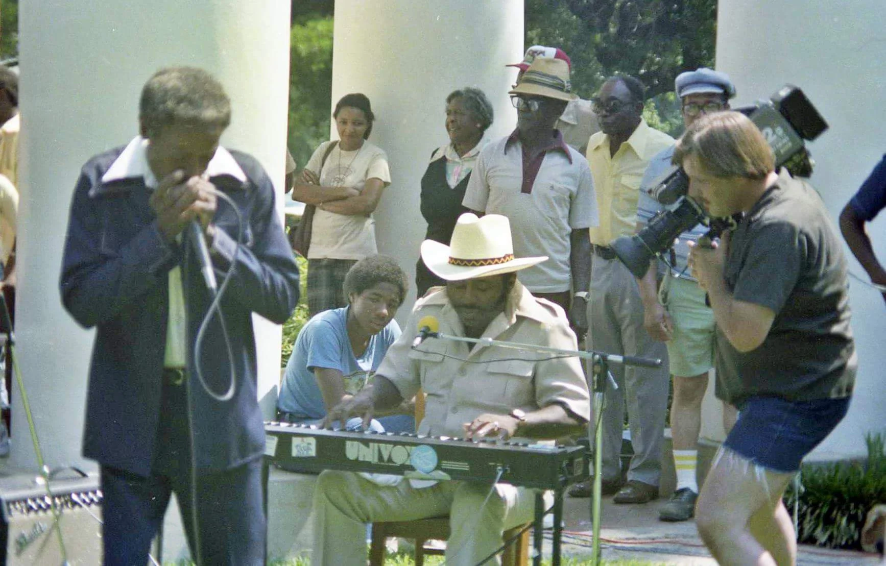 From L. to R. Moses "Whispering" Smith (harp), Chris Thomas King (sitting) Tabby Thomas (piano) Guitar Kelly (Standing) (staw hat) circa 1978.