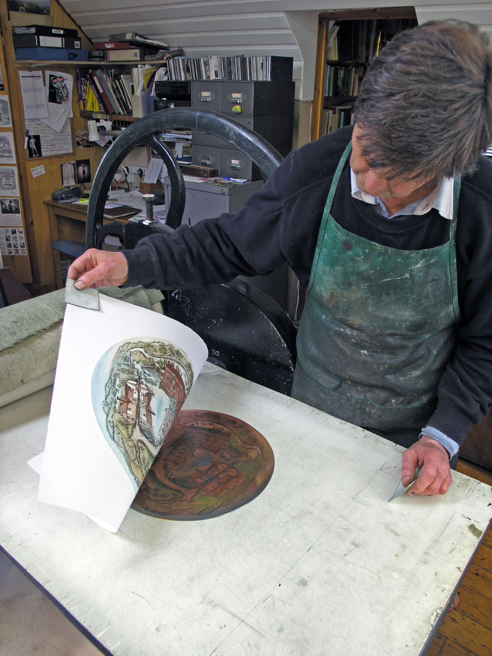 Glynn Thomas lifting a print from the press