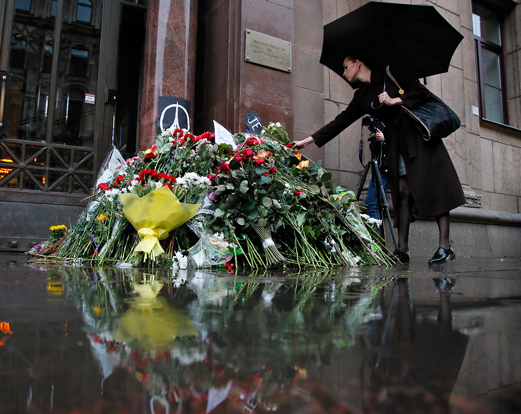 A woman lays flowers in front of the French consulate in St.Petersburg, Russia, Saturday, Nov. 14, 2015, for the victims of the Paris attacks on Friday. French President Francois Hollande said more than 120 people died Friday night in shootings at Paris cafes, suicide bombings near France's national stadium and a hostage-taking slaughter inside a concert hall. Photo by Dmitry Lovetsky/AP