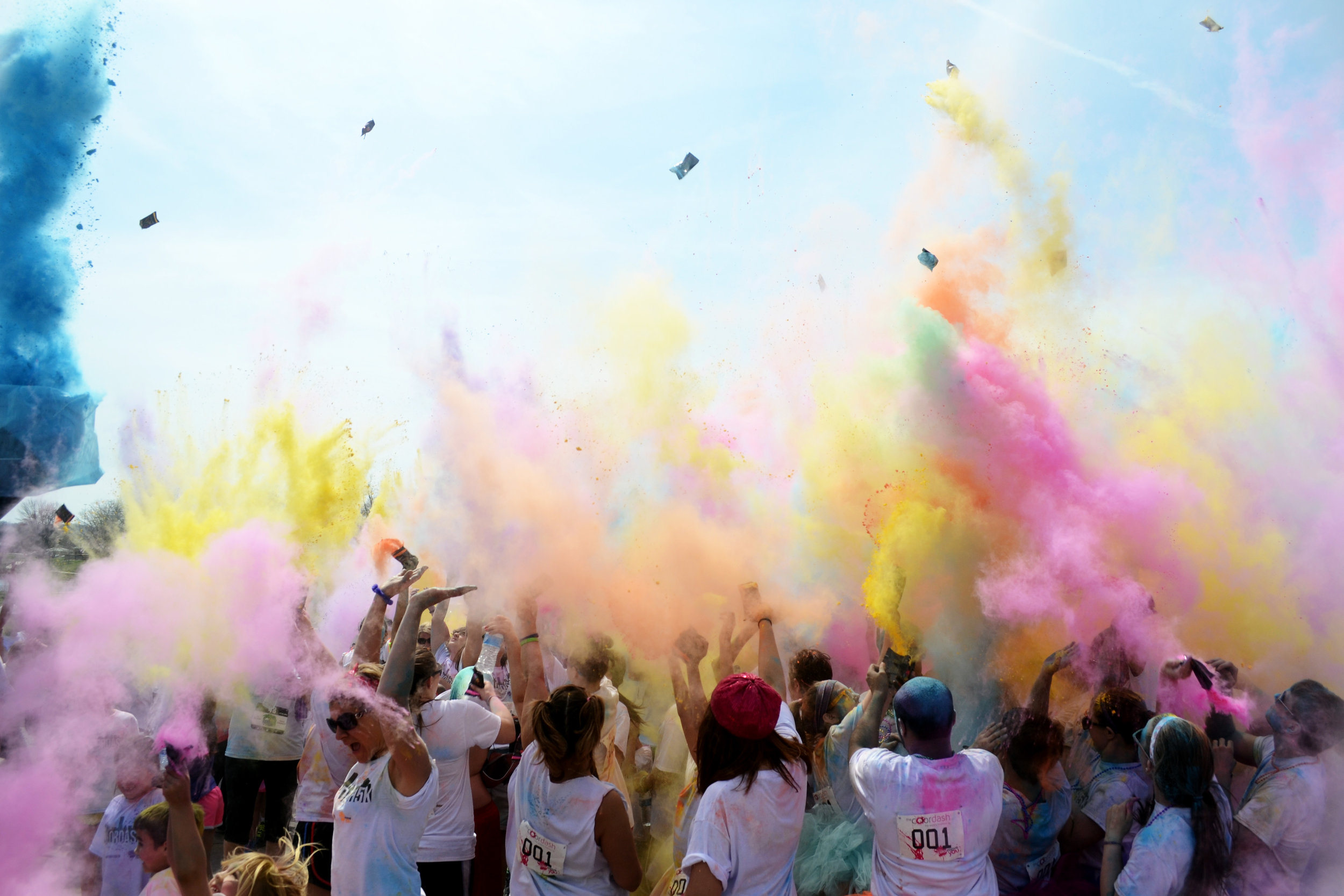  People celebrate with a 'color explosion' after completing the Color Dash 5K at Stephens Lake Park in Columbia, MO, on Saturday, April 6, 2014. Proceeds from the event went toward the local Humane Society. 