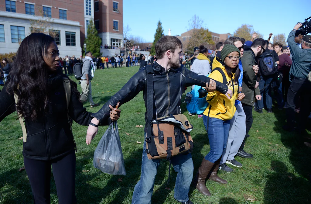People form a human chain trying to keep media out after Jonathan Butler's hunger strike was brought to an end Monday morning as UM System President Tim Wolfe officially resigned Nov. 9, 2015. Photo by Justin L. Stewart/Missourian