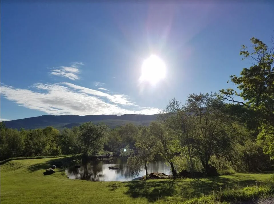Sunny view of the pond from the front porch of our Vermont Bed and Breakfast