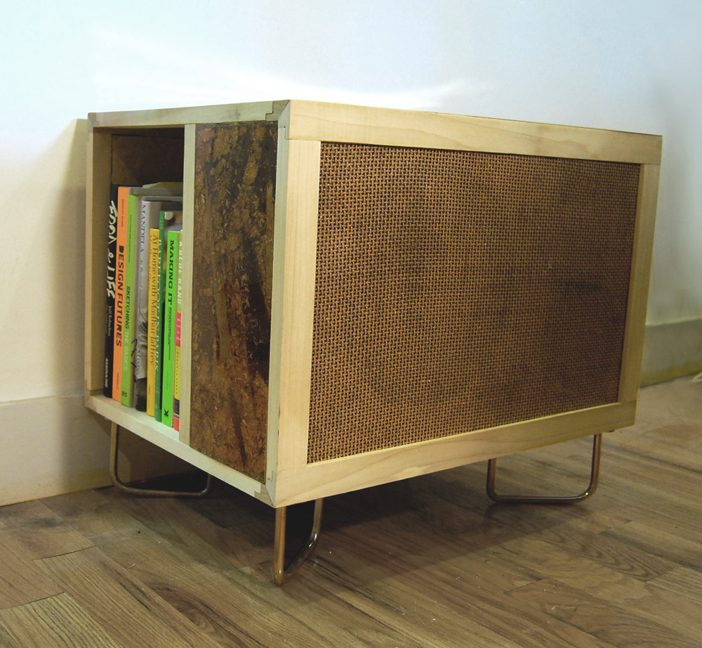  The Lucy Table contains a speaker in front, side shelving, custom joinery and cast resin/fiberboard composite. 