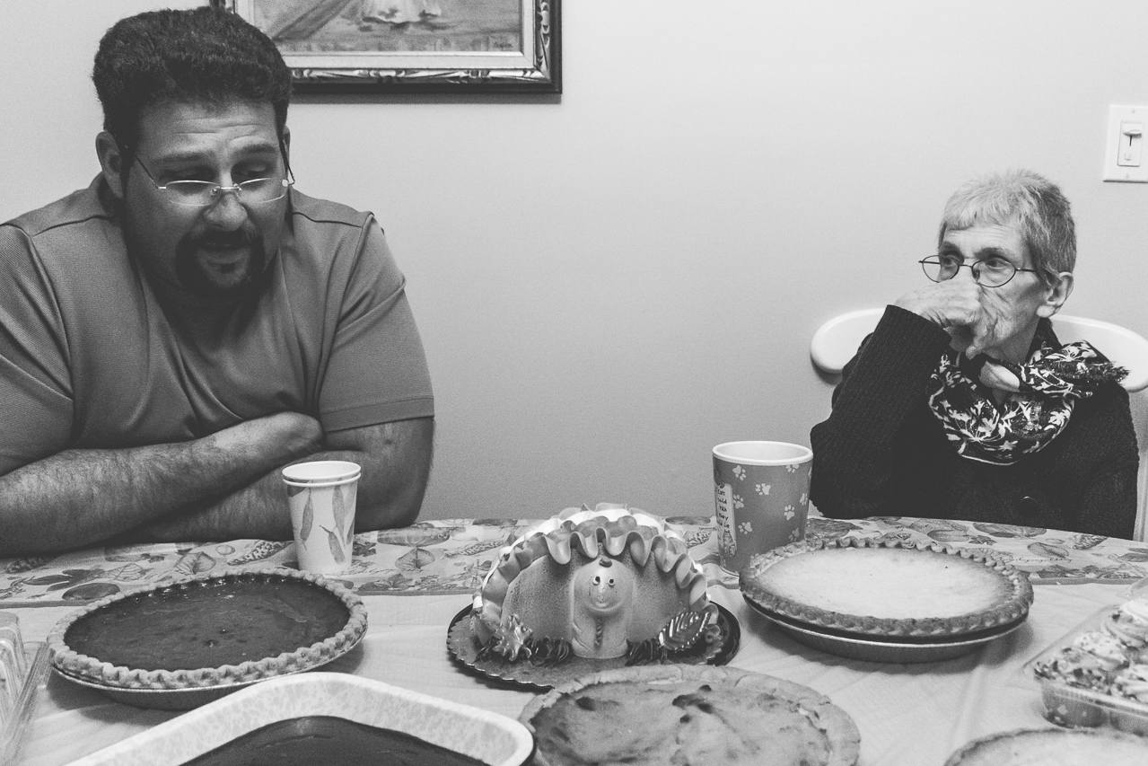 New Jersey Family Photographer - black and white photo of a man and elderly woman at dinner table