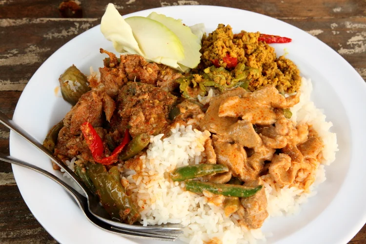 Load up a plate with Thai curries for super cheap at Khao Kang. Google Images.