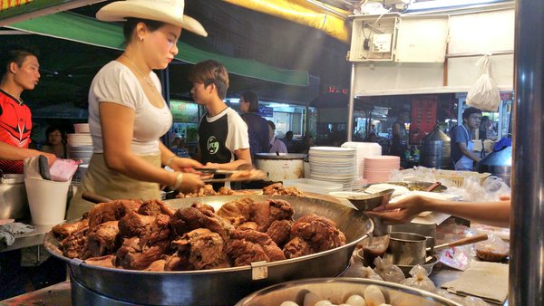 The "Cowboy Lady" made famous by Anthony Bourdain, hard at work on her pork magic in Chiang Mai, Thailand. Google Images.