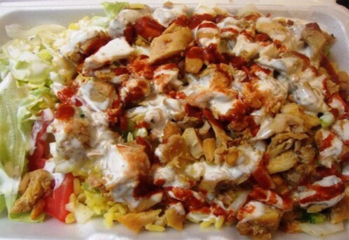 Sammy's chicken and rice. There's 2000 calories looking at ya. Looks hideous, tastes awesome. No better method for late night sopping up of booze exists in the neighbrohood. Google Images.