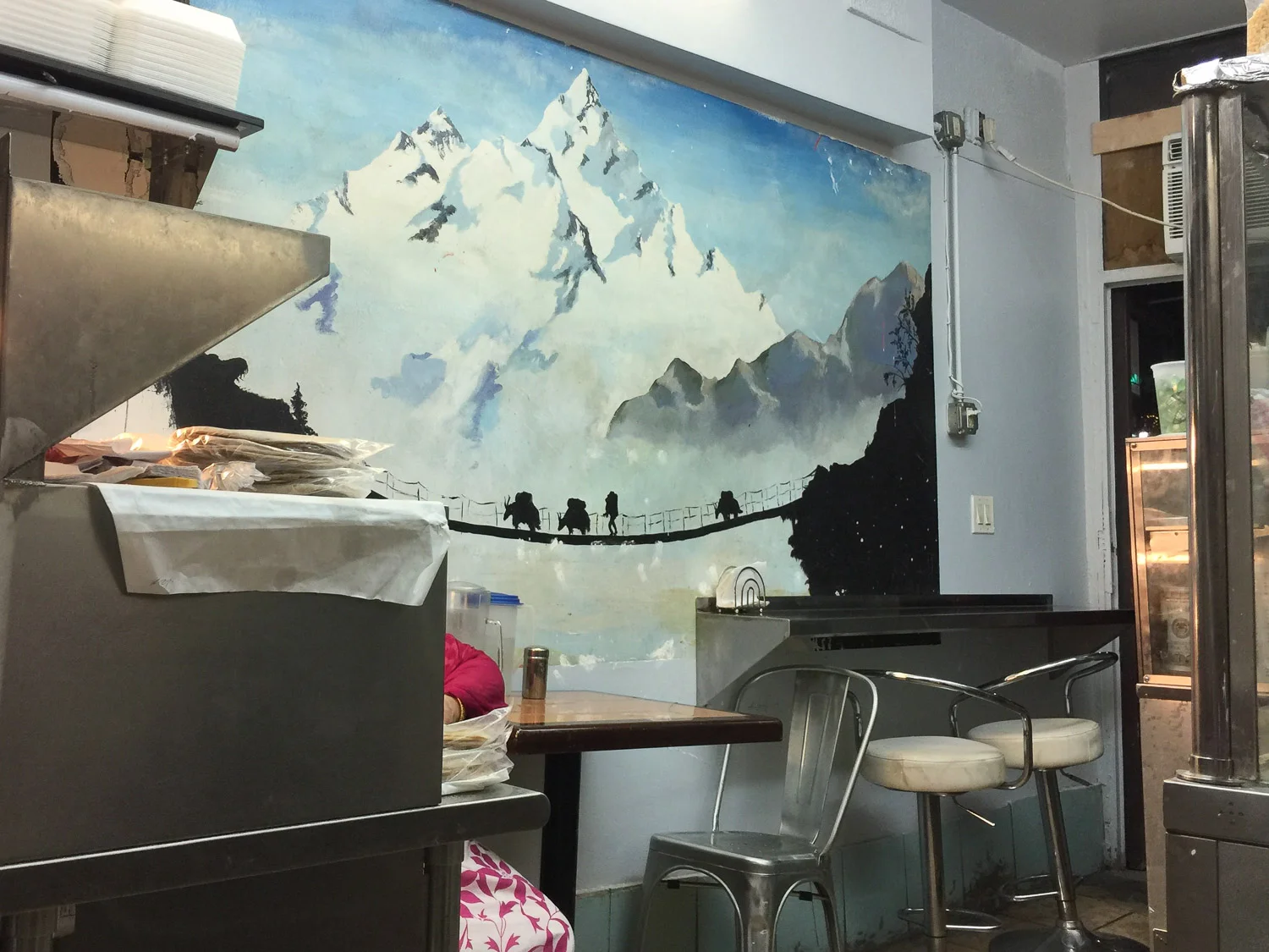 Tawa Roti's kitchen and dining room is one long corridor-like space. I love the Himalayan mural. 