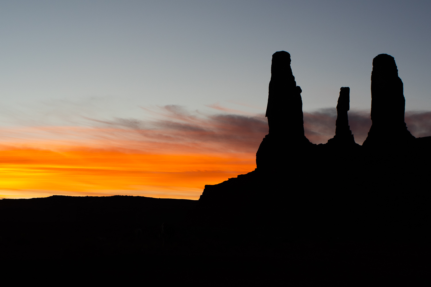 The sun sets behind the Three Sisters.