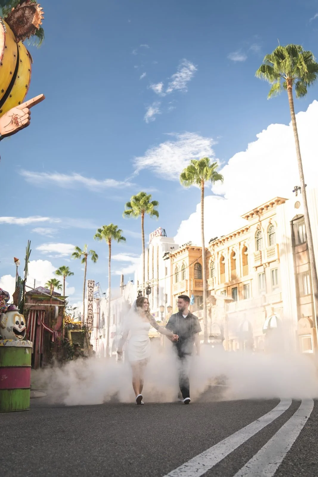 Couple walking through fog under palm trees at Universal Studios Florida during HHN 35