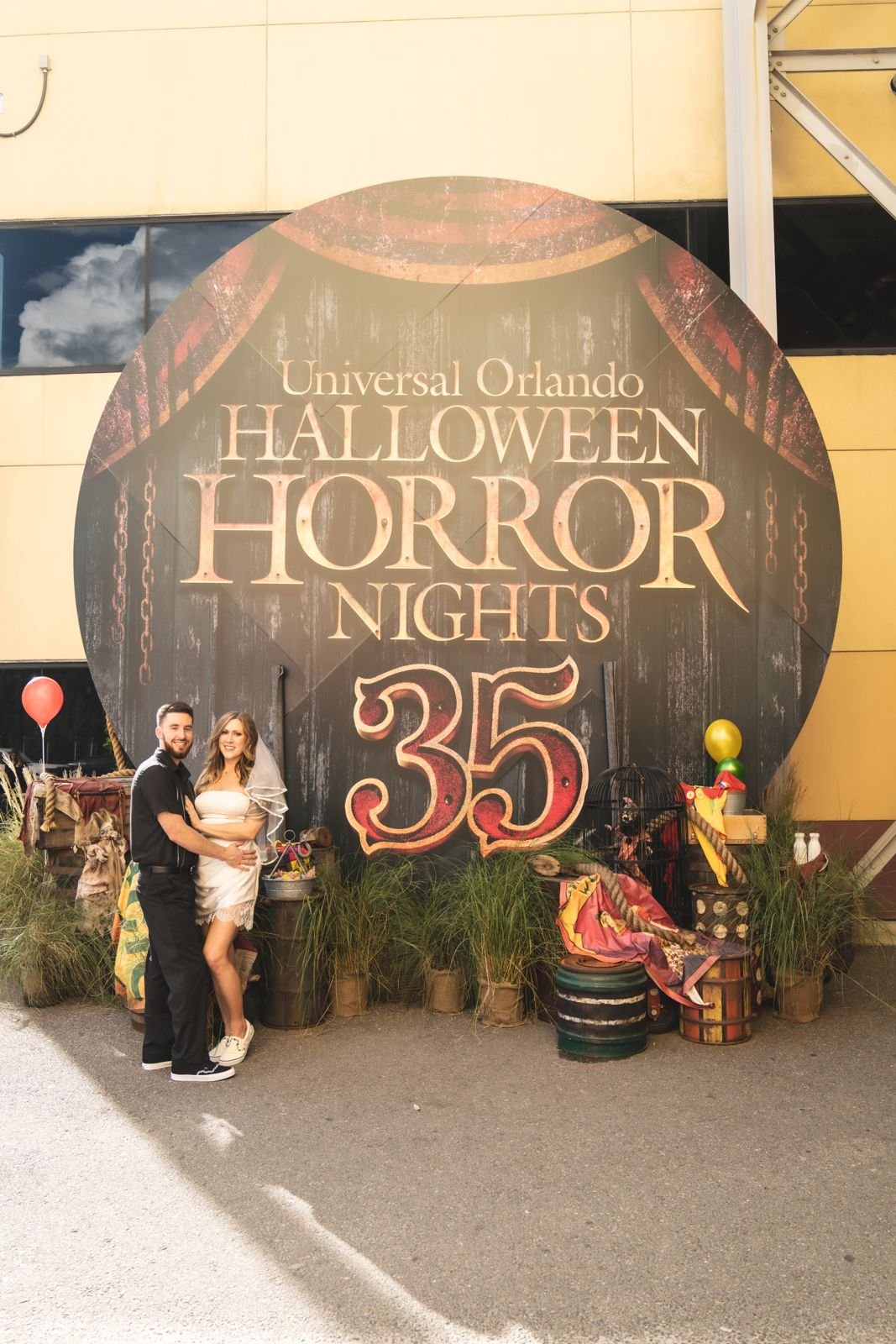 Couple in front of the giant Halloween Horror Nights 35 sign at Universal Orlando