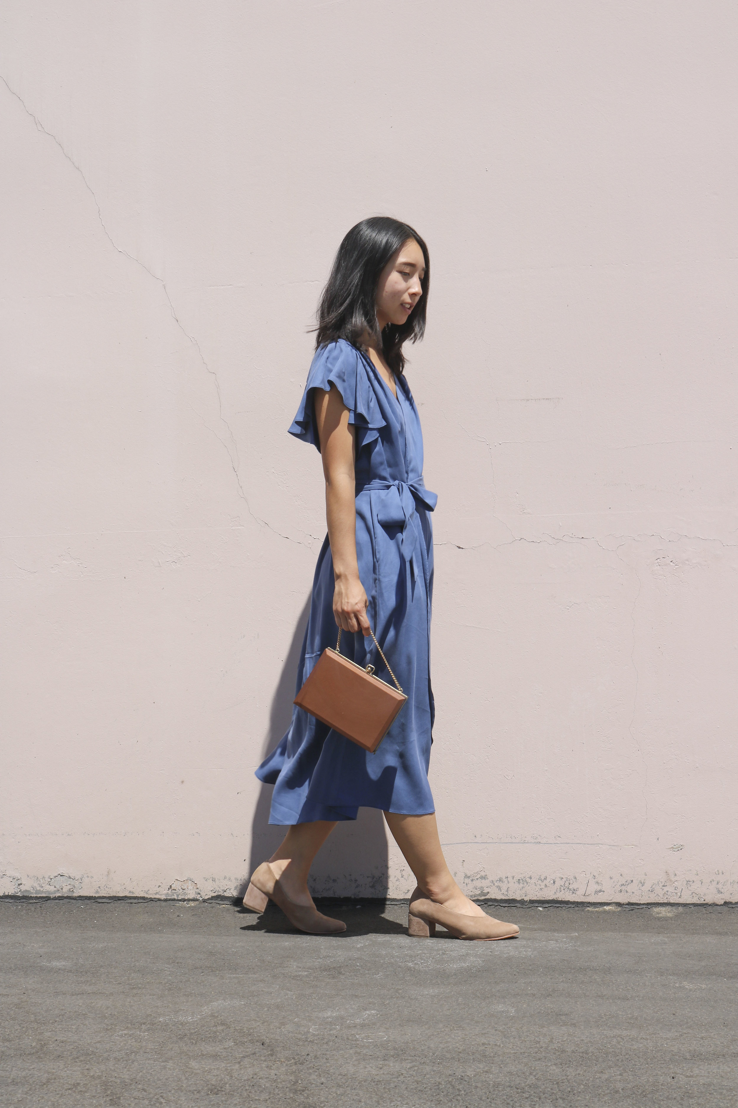 Sarina styles the Belu Pump with a wrap dress by Georgette Crimson and a vintage box purse.&nbsp;