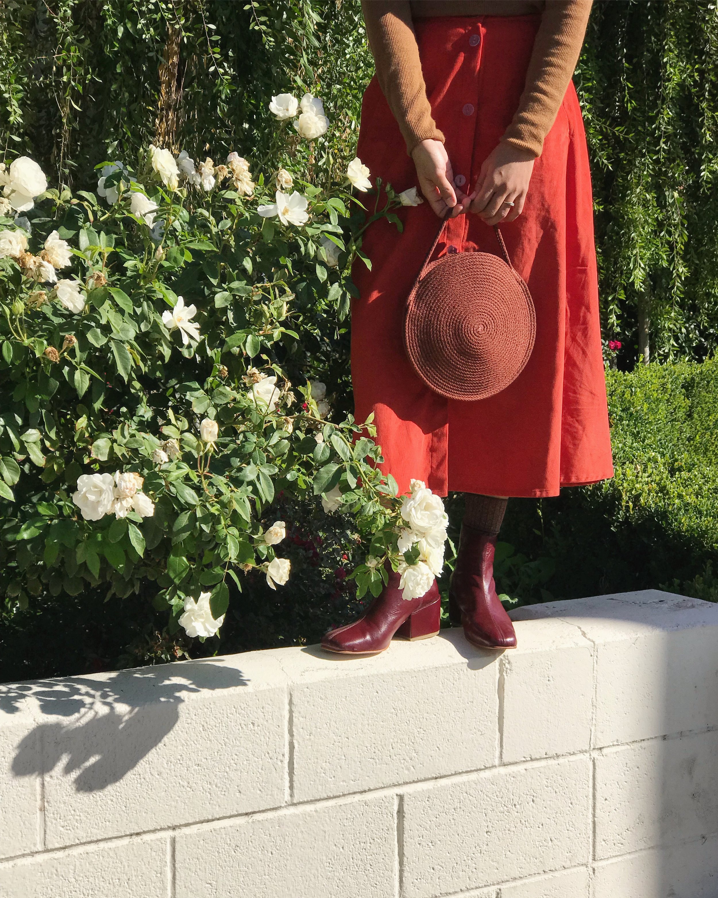 Melissa in the Mulberry Beia Boot styled with a Catzorange circle tote and the Megan Huntz Leslie Skirt