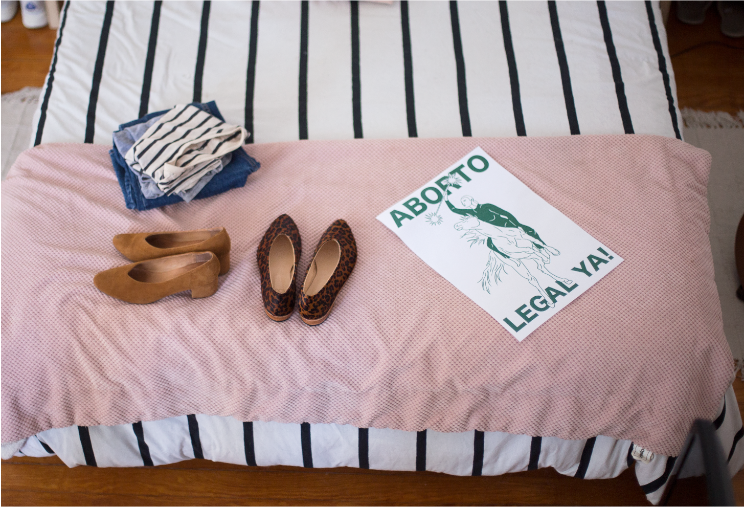 Above, a folded pile of Daiana’s comfortable but stylish uniform of denim and tees; the ZX Belu Pump in a past season color and the Glove Flat in Leopard Pony; A poster Daiana designed + illustrated in the color green for Argentina’s ‘Legal Abortion…
