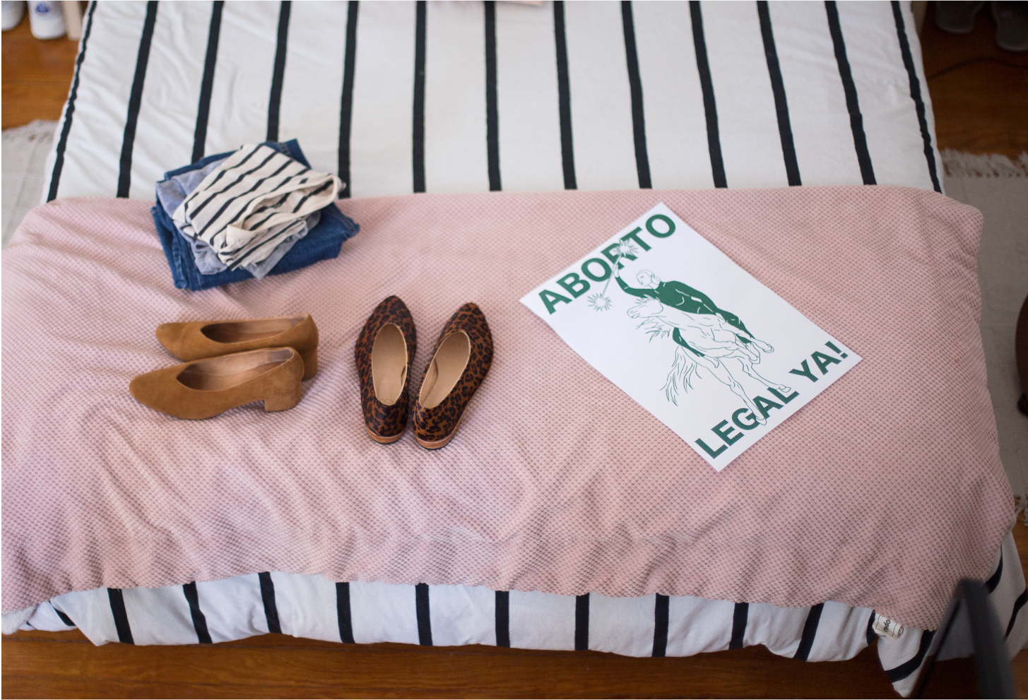 Above, a folded pile of Daiana’s comfortable but stylish uniform of denim and tees; the ZX Belu Pump in a past season color and the Glove Flat in Leopard Pony; A poster Daiana designed + illustrated in the color green for Argentina’s ‘Legal Abortion Now’ August 2018 march.