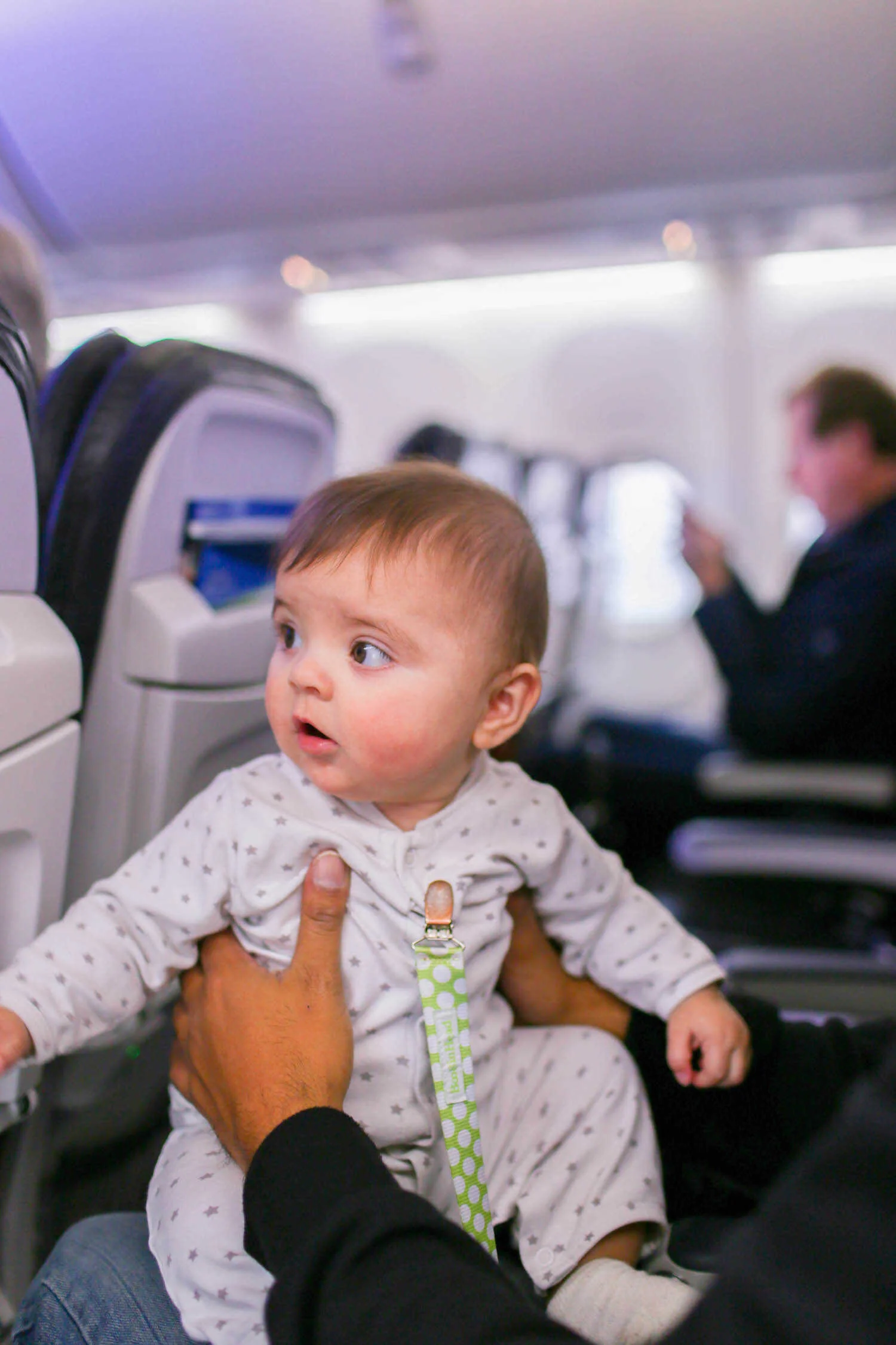 Daddy holding baby Scout on the airplane to Hawaii.